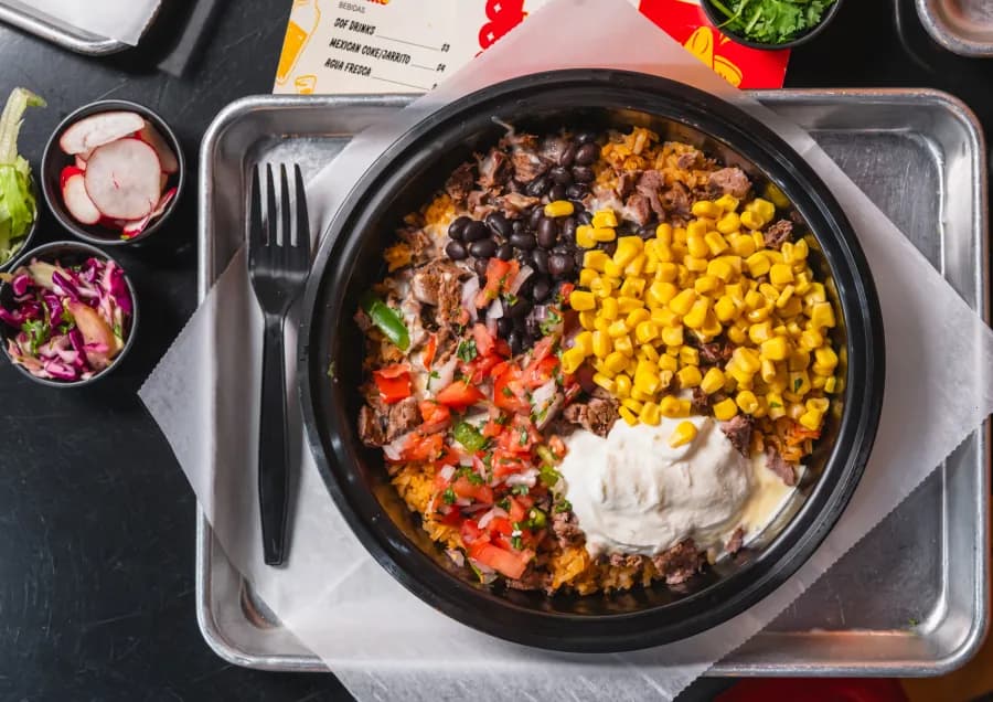 Rice bowl served with crema and guacamole